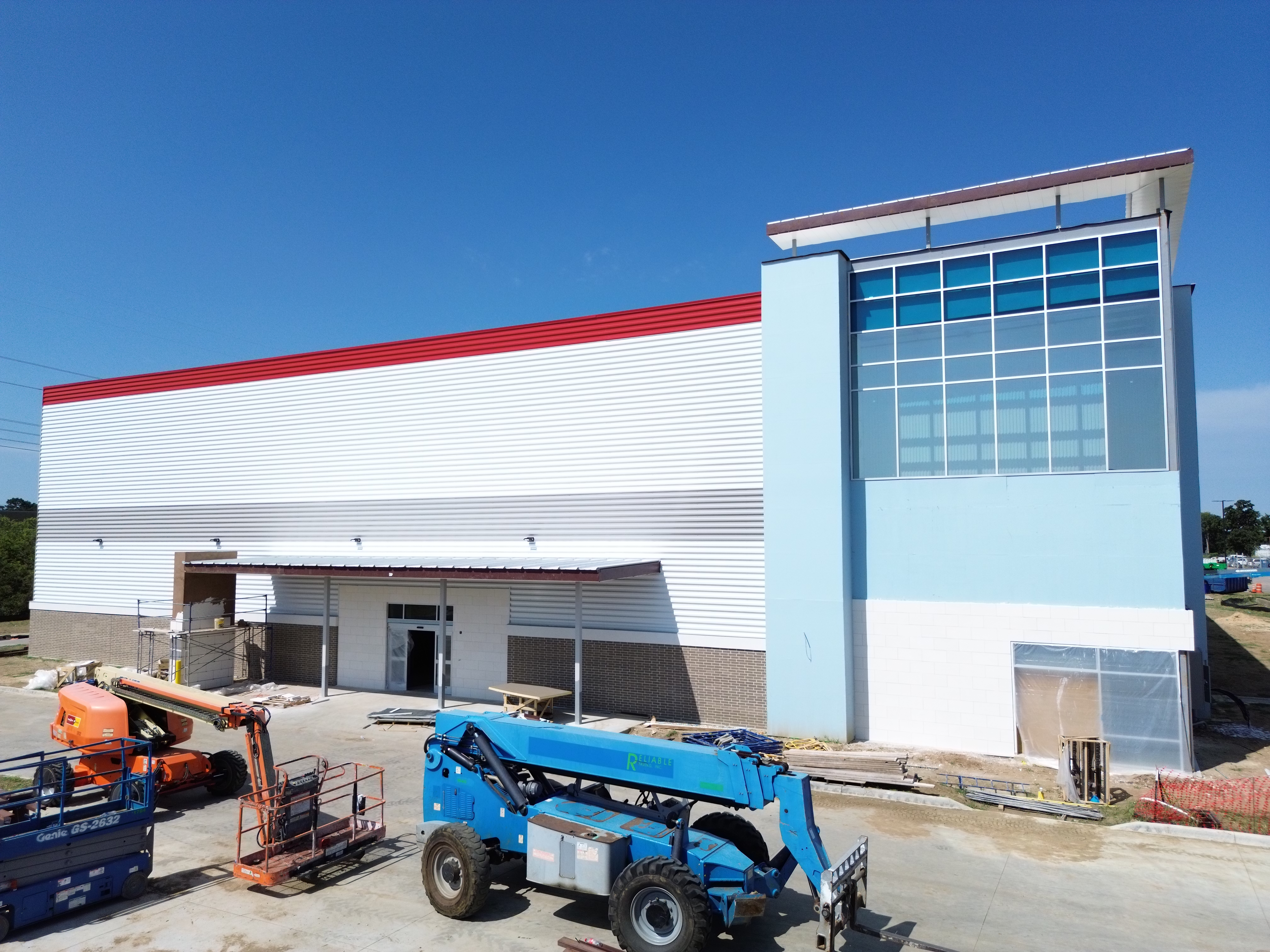 Commercial building under construction with exterior wall panels and glazing installation by Reliable Commercial in the Dallas-Fort Worth area