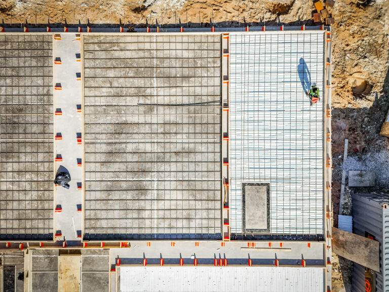 Aerial view of a rebar foundation grid at a commercial design-build construction site in Dallas-Fort Worth